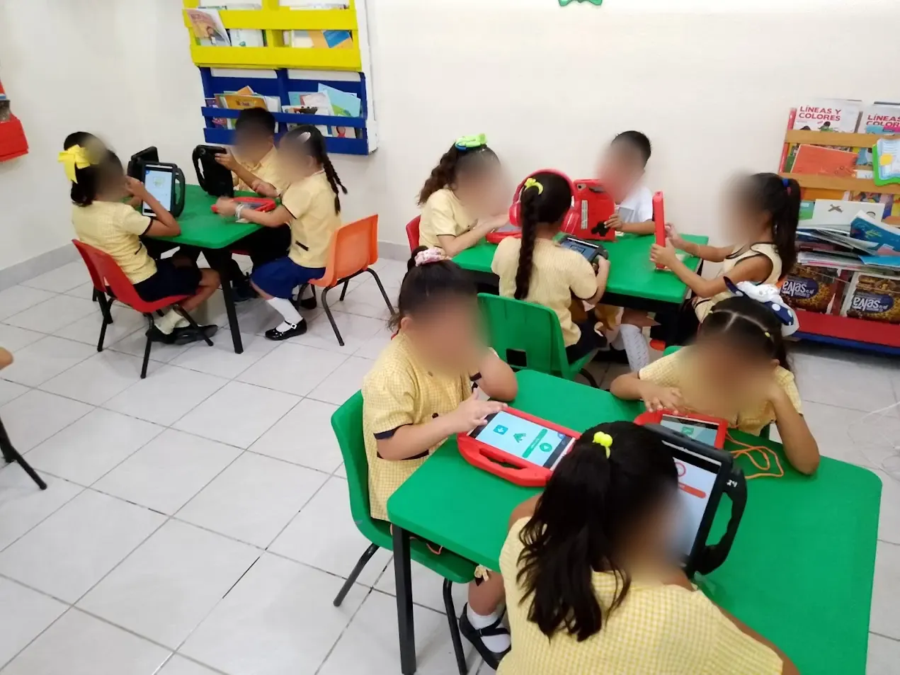 Children working in small groups with tablets at school
